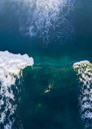 A surfer in between of sea poster